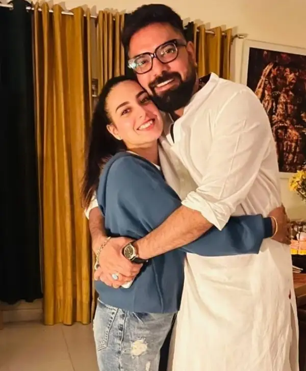 Yasir Hussain hugs his wife after cutting the birthday cake.