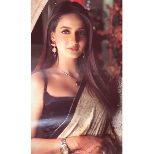 She looks stunning wearing a saree.