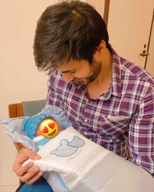 Actor Hasan Khan holding a baby