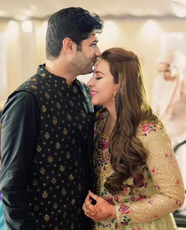 Obaid kisses her forehead during the wedding photoshoot.