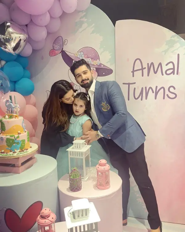 A picture of Aiman Khan holding her daughter Amal Muneeb