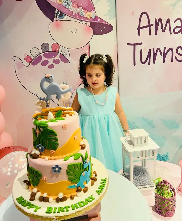 In this picture, Amal Muneeb is cutting the cake from her 3rd birthday party