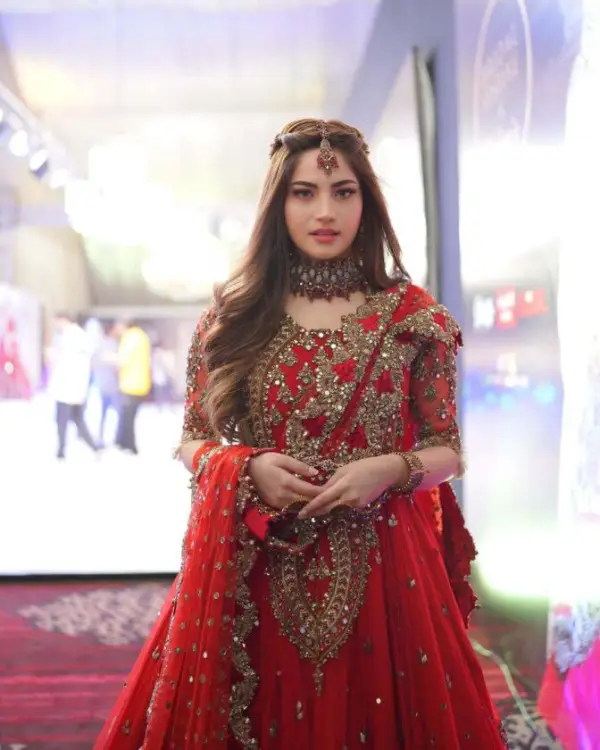 A picture of Neelam Muneer wearing red dress at the runway of Bridal Festive by Kashee