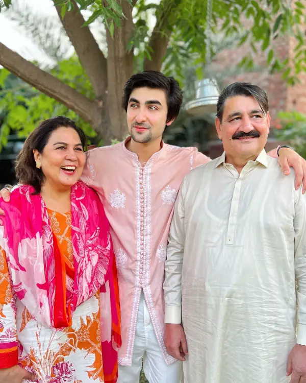 An image showing him with his father and mother