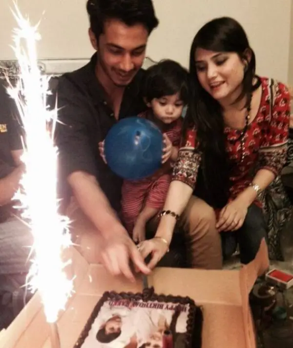 During the birthday celebration of their oldest son, the husband and wife cut the birthday cake