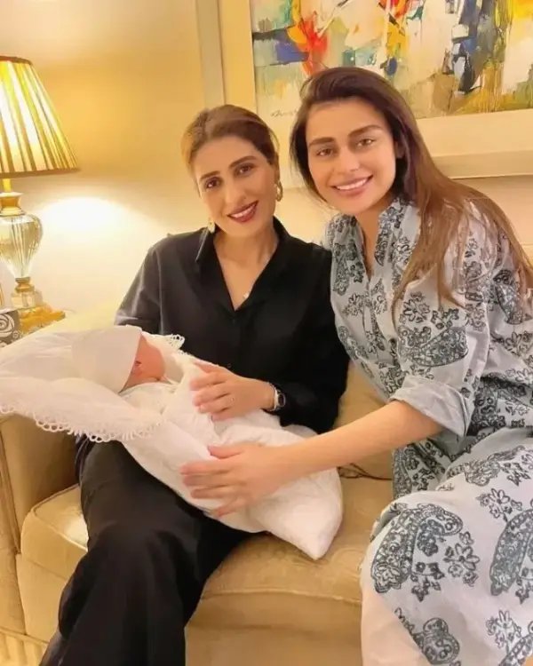 An image of Sadaf Kanwal holding her newborn daughter