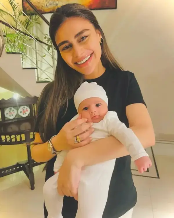 An image of Sadaf Kanwal holding her newborn baby girl