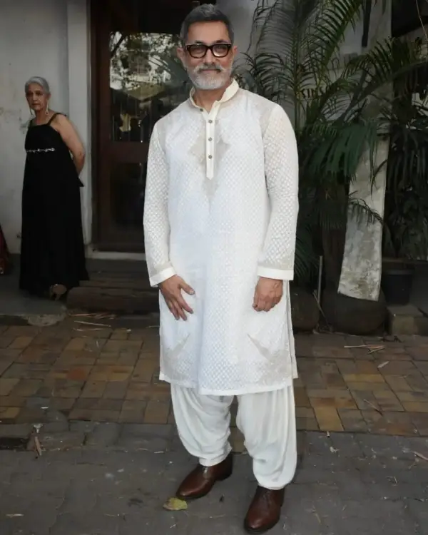 On the occasion of his daughter's engagement ceremony, the Bollywood actor Aamir Khan wears an elegant white dress