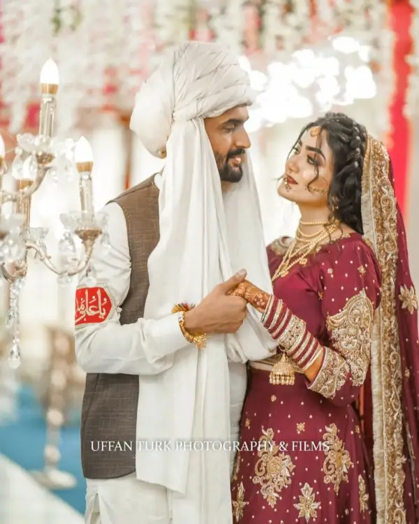 Raza posing with his wife during their wedding shoot