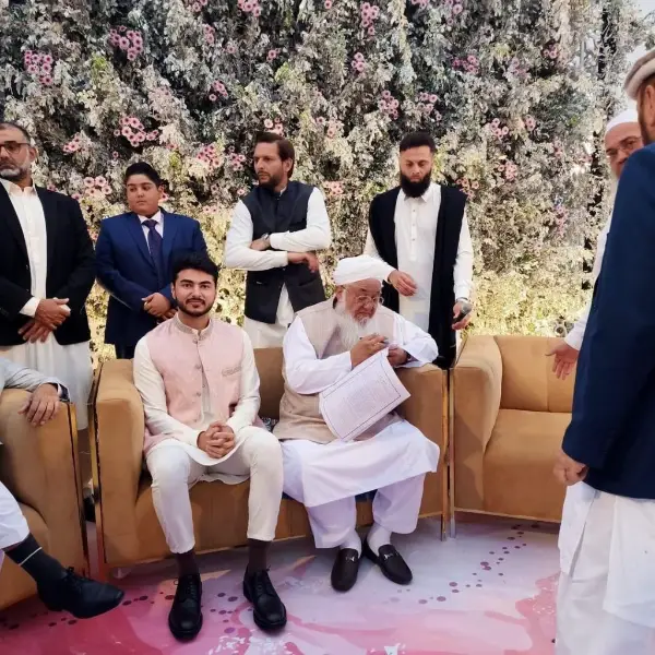 A picture of the groom Naseer Nasir wearing a white dress during the nikkah ceremony