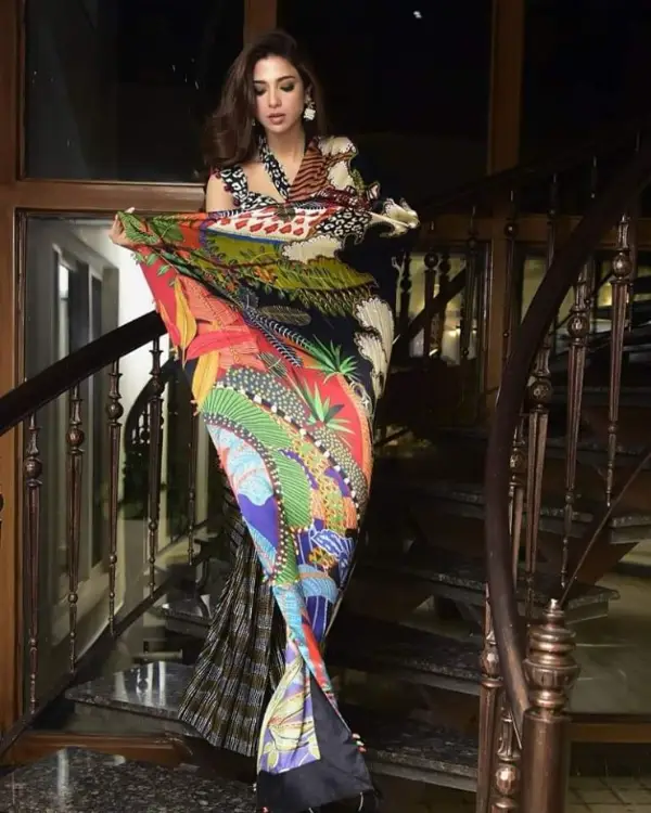 Taking a step down the stairs, a picture shows the actress looks stuning in saree