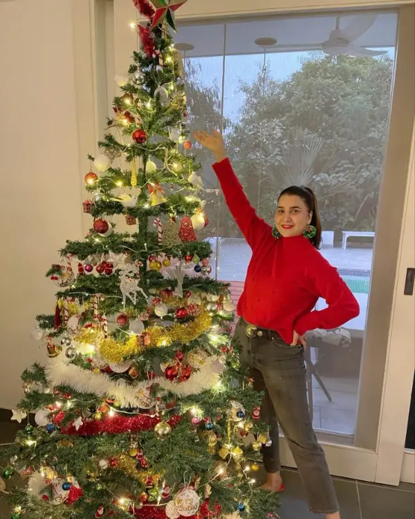 An image of Pakistani actress Areeba Habib posing with a Christmas tree