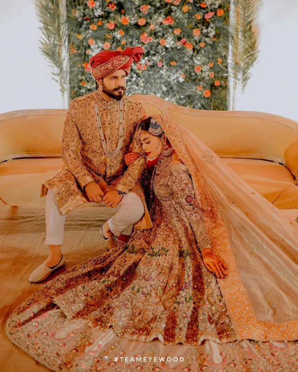A wedding picture of Azlan Shah on a sofa with his wife next to him