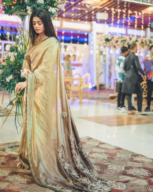 She looks beautiful in a golden saree