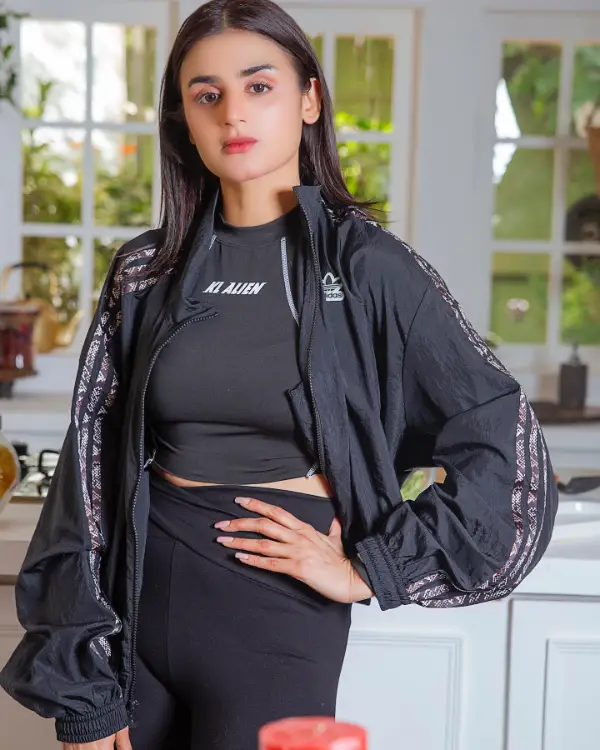 A picture of the actress wearing a crop top with long sleeves in black
