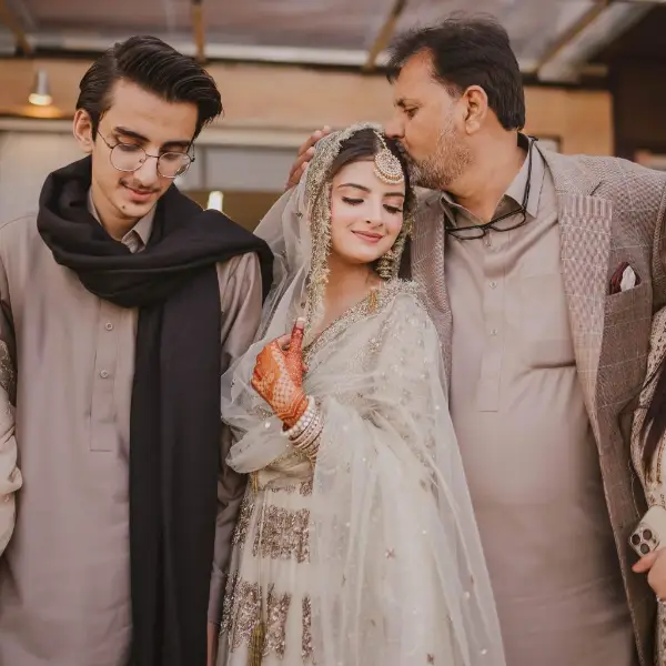Muzna Masood Malik with her youger brother and father