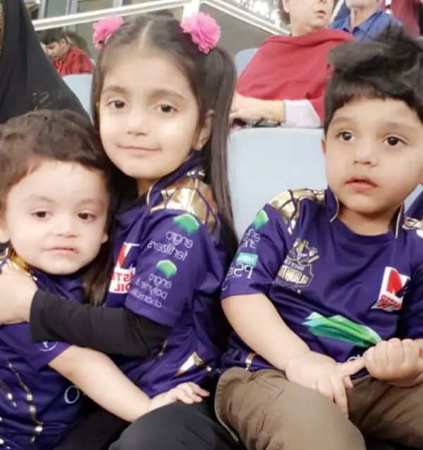 A cute picture of his kids watching a cricket match at the stadium