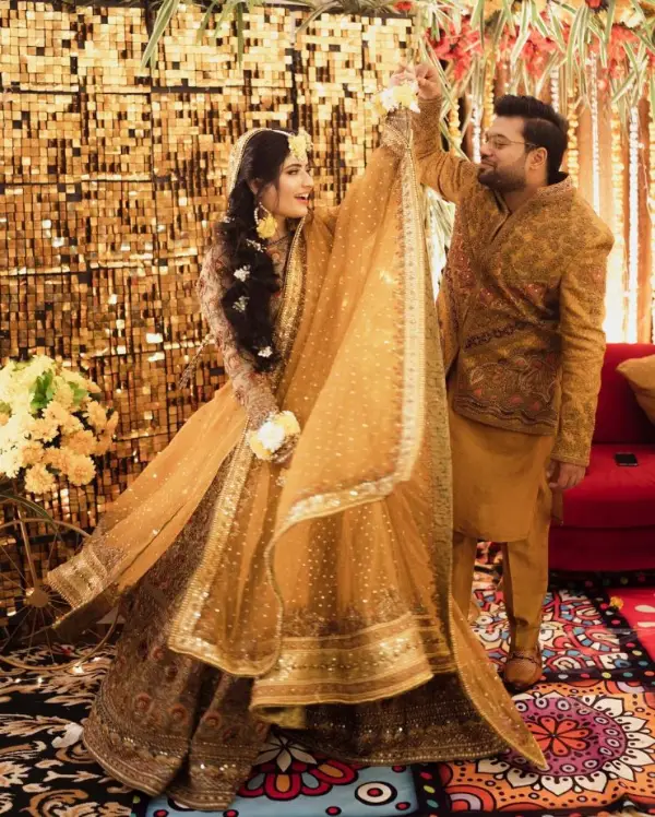A picture of the bride and Ducky Bhai dancing together at their mehndi