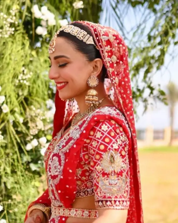 This is a picture of actress Ushna Shah wearing a red wedding dress