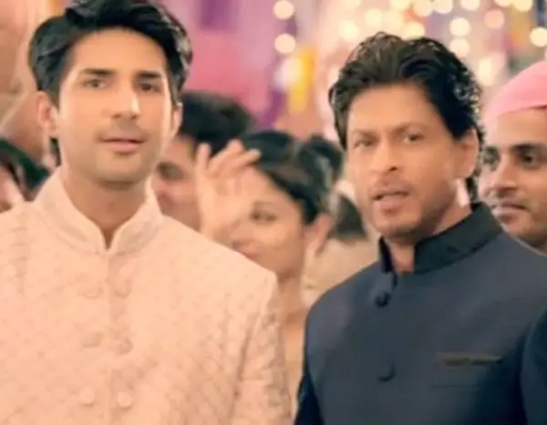 Shah Rukh Khan and Adeel posing during a television commercial