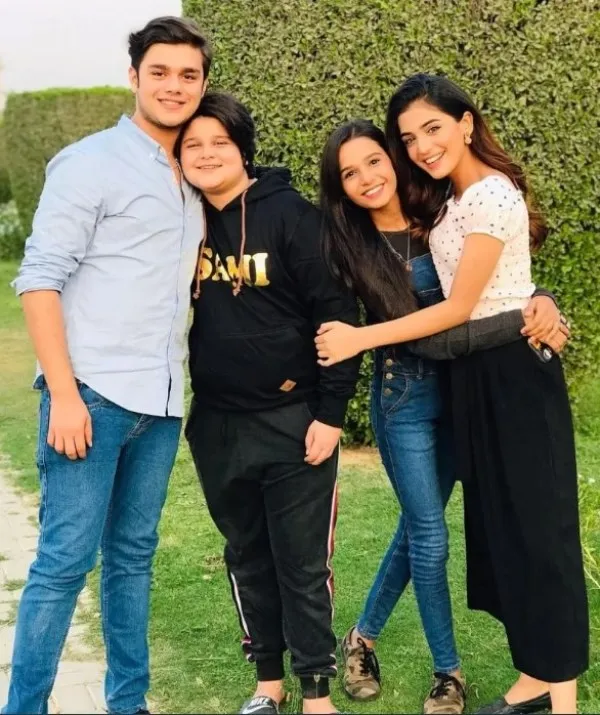 A picture of her with her brothers Aadi Khan and Sami.