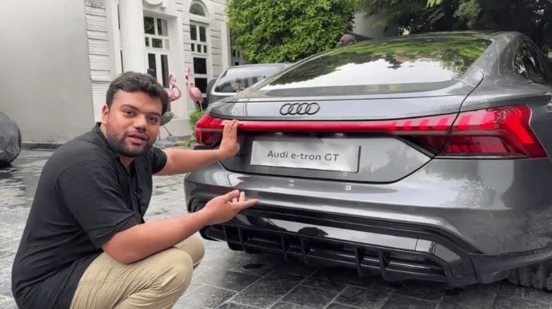A Picture of Ducky Bhai showing his fan the side of his dream vehicle