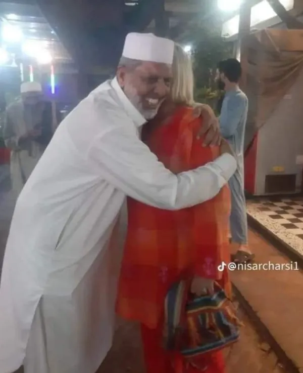 Nisar Charsi Tikka Owner embracing a tourist 