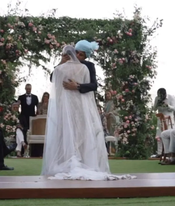 Guests witness the couple hugging each other