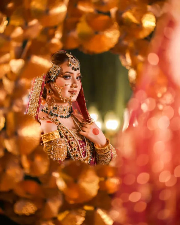 Rabeeca Khan's bridal look, showcasing intricate jewelry and a richly embroidered outfit.
